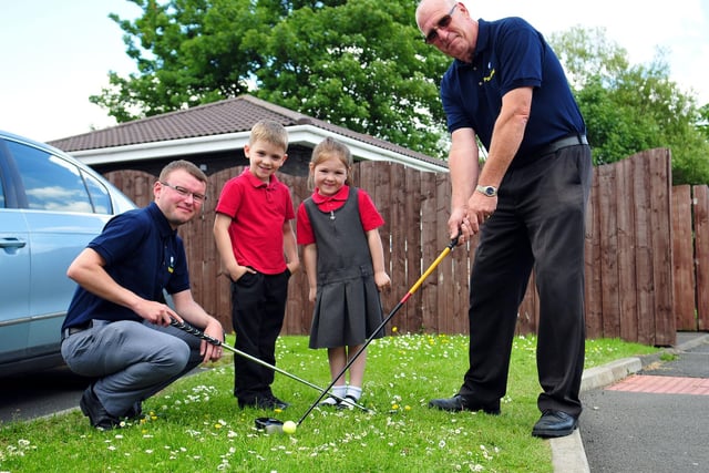 Stranton Primary school pupils Keane Pierse and Lucy Relton look on as David Miller, IT manager, and Brian Ward, site manger, play golf in 2014.