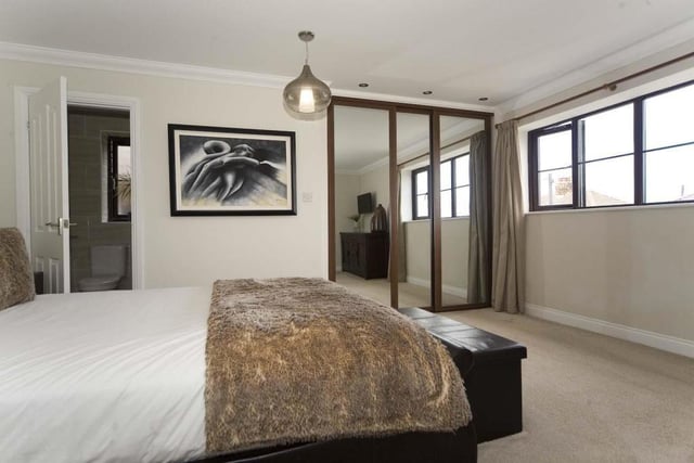 The master bedroom features a mirrored closet and en-suite facilities.