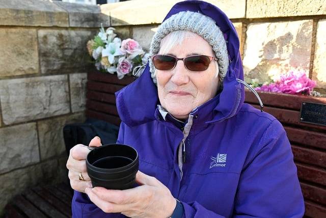 Florence Franklin braves the cold with her cup of tea on the Headland in 2024.