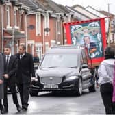 The Horden miners' banner follows Dr Joseph Chandy's funeral procession.