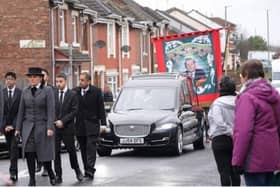 The Horden miners' banner follows Dr Joseph Chandy's funeral procession.