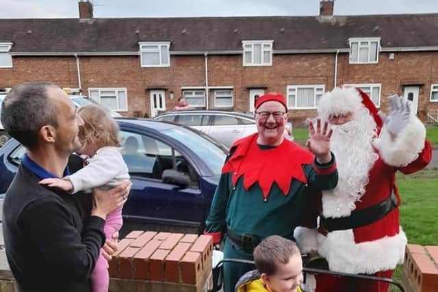 Here he comes. Santa and his elf visit another Hartlepool family.