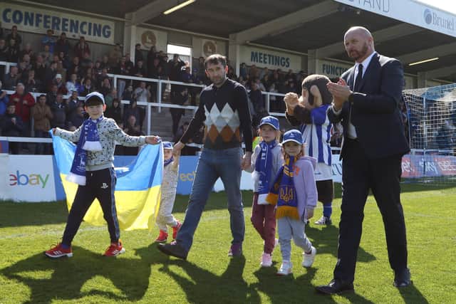 A Family of Ukrainian Refugees and Stephen Hobin parade at the Suit Direct Stadium ahead of the League Two match between Hartlepool United and Swindon Town. (Credit: Michael Driver | MI News)