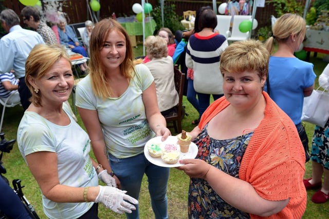 Clare Wilson and her daughter Rachel have a cake with Jane Cooke at the Carelink Northern fun day eight years ago.