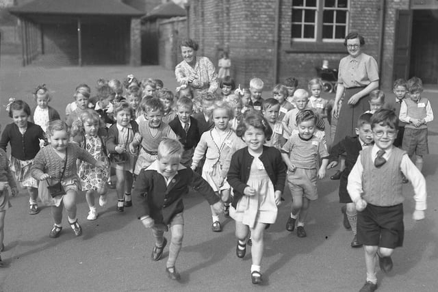 Children from Jesmond Road primary school leap with excitement in the playground in 1932.
