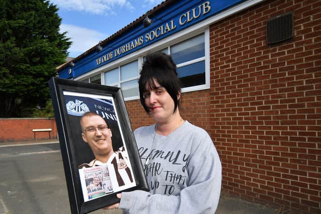 Kristina Thorpe-Aspinall holding a photograph of her late brother Danny Thorpe.