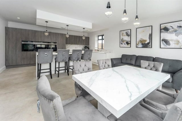 This open plan kitchen and diner is perfect for hosting and even has underfloor heating.