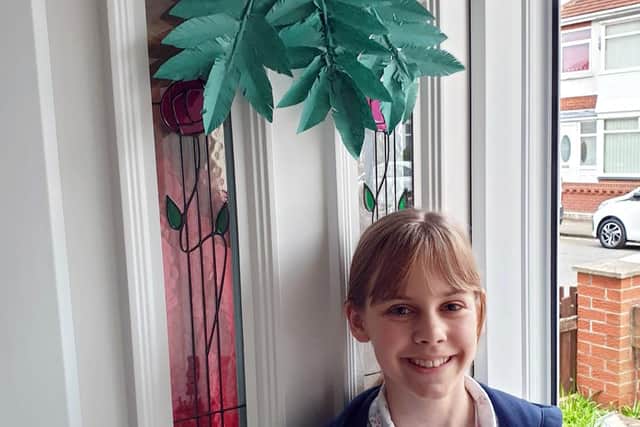 Charlotte Boagey made a palm leaf for everyone in her home to hang on the front door.
