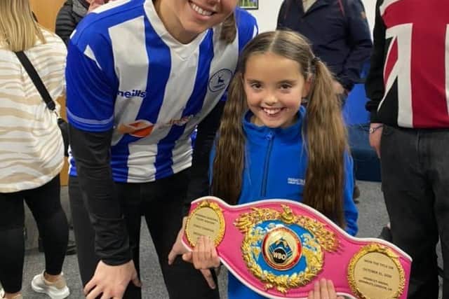 Savannah with a young fan in the Hart Of Our Club lounge at Victoria Park where Savannah is a lifetime member.