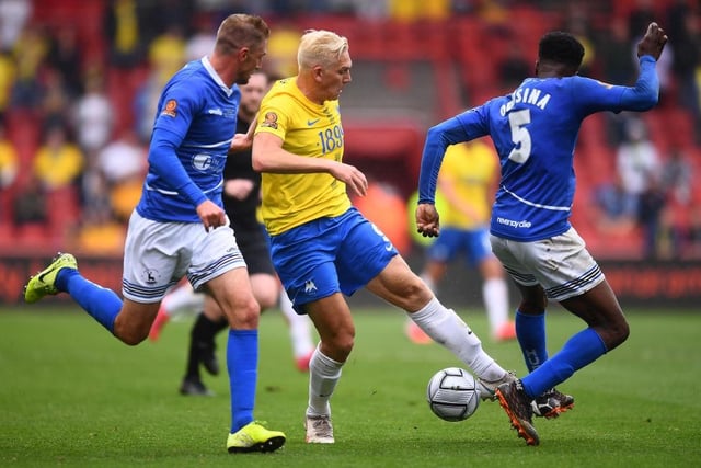 Danny Wright of Torquay United battles for possession with Timi Odusina and Gary Liddle of Hartlepool United during the National League promotion final at Ashton Gate on June 20, 2021. (Photo by Harry Trump/Getty Images)