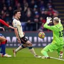 Liverpool's Diogo Jota goes down under a challenge from Crystal Palace goalkeeper Vicente Guaita and a penalty is awarded after a VAR check during the Premier League match at Selhurst Park.