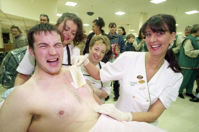 Asda employee Martin Longstaff of Peterlee was waxed for a good cause in 1996. He raised money for the British Heart Founation with lecturer Liz Elliott of East Durham Community College and students Joanne Cowley, left, and Doreen Shaw watching.