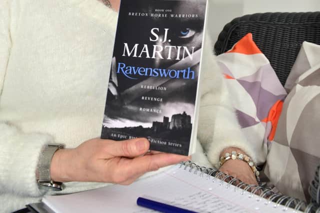 Author Breffni Martin with a copy of her debut book Ravensworth.