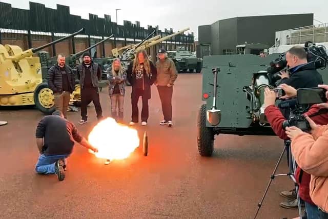 The gun powder from a charge is burned as members of Sabaton look on. Picture by FRANK REID