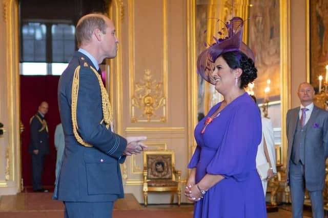 Brenda McLeish chats to Prince William as she is presented with her OBE at Windsor Castle.