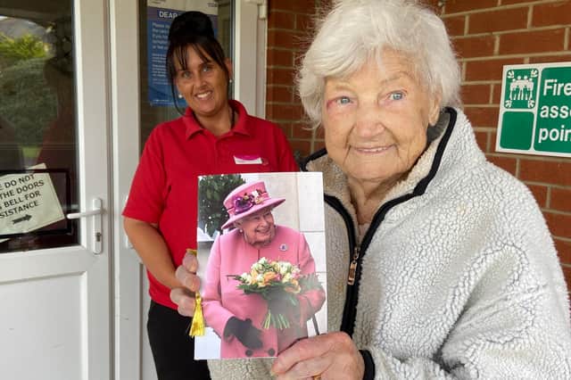 Ethel Wray holds her card from The Queen with West View Lodge activities co-ordinator Ann Roberts.