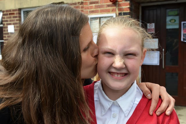 Sacred Heart Primary school pupil Leah Coulson - who did not miss a day at school - gets a kiss from her mum Bev in 2015.