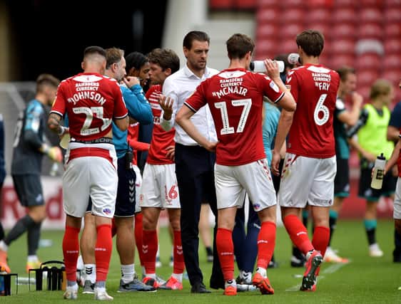 Middlesbrough boss Jonathan Woodgate speaks to his players.
