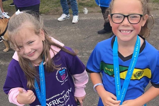 Dottie (left) poses with her medal after the run. The charity raised £35,000 for a life changing operation for Dottie, who has cerebral palsy.