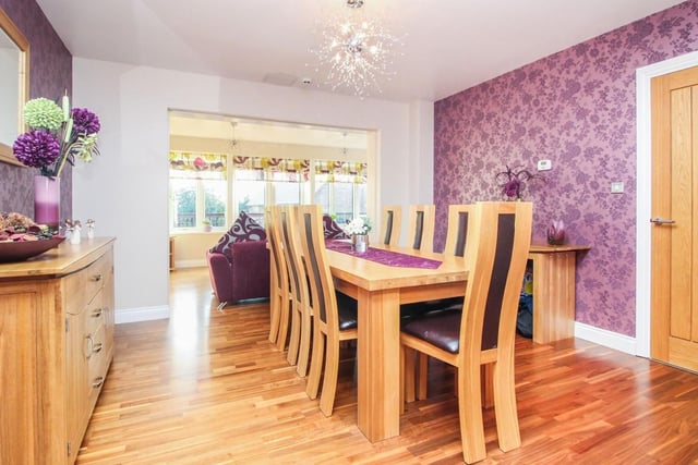 The modern dining room boasts oak laminate flooring, underfloor heating, and access to both the garden room and kitchen area.