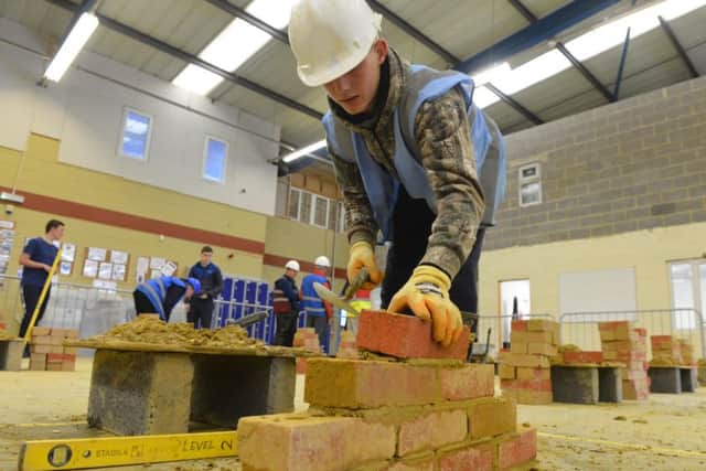 Pro-active Training open day to help young people in Hartlepool into work. Harlea Murray having a go at bricklaying.