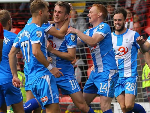 Rhys Oates is congratulated by his Hartlepool United teammates at Leyton Orient last season.