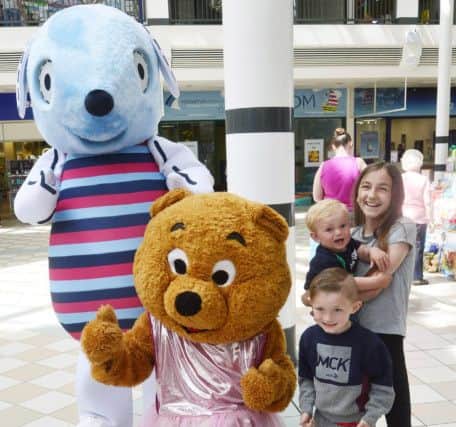 Mascots Daisy and Buddy with Lauren Twidale(right), 11 month old Lucas Twidale and four year old Gabriel Manson.