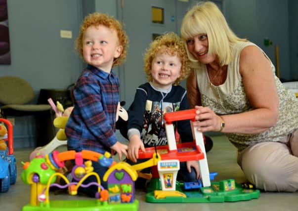 Brothers Max (left) and Jack Marsden with Christine Carter playgroup leader at from Place in The Park. Picture by FRANK REID