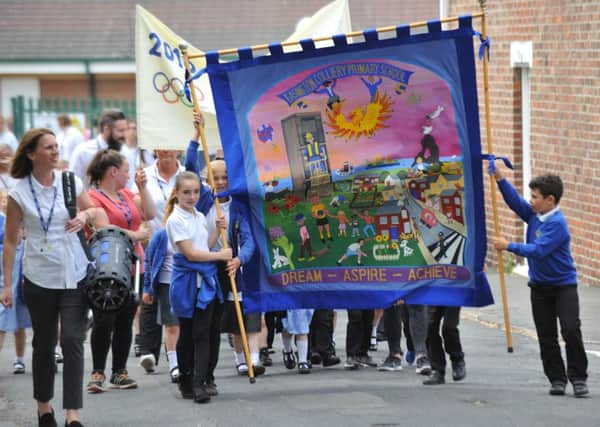 Pupils and staff from Easington Colliery Primary School parade around the streets to celebrate the school's 20th anniversary.
