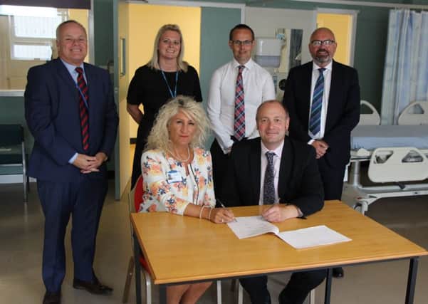 Trust chief executive Julie Gillon with college principal Darren Hankey; and back row (left to right) trust non-executive director Steve Hall, trust workforce project manager Vicki Spinks, trust deputy director of workforce Gary Wright and college vice principal Andrew Steel.