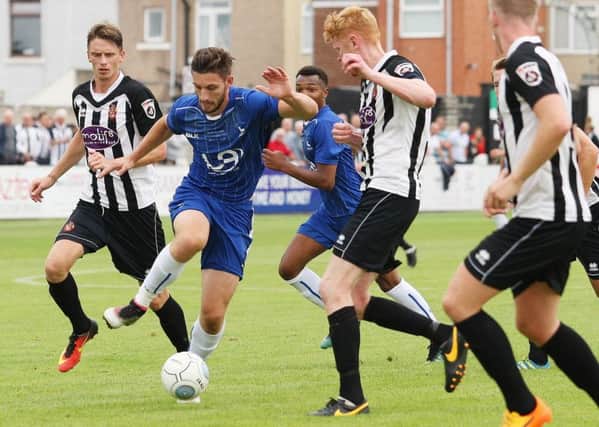 Jake Cassidy puts the Spennymoor defence under pressure.