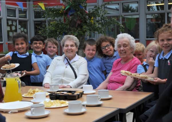 Pupils at Ward Jackson C of E Primary school serve tea and cakes to visiting pensioners.