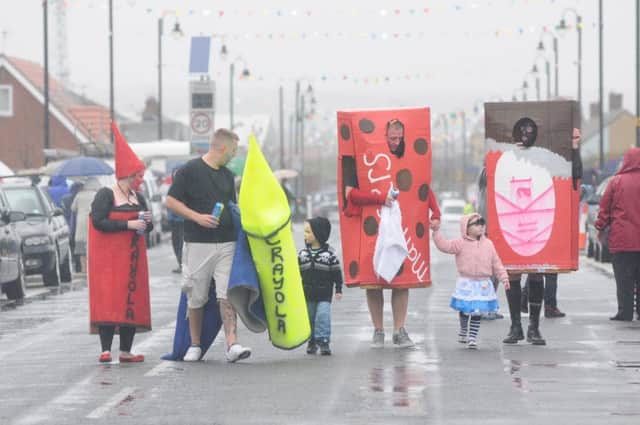 The Headland Carnival fancy dress parade underway in 2011 and they still had fun even though the heavens opened.