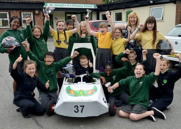 St Joseph's RC Primary School pupils with science co-ordinator Tracy O'shea and the car their electric car. Picture by Frank Reid