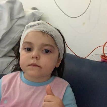 Brave Lyla gives a thumbs up after her latest bout of surgery.