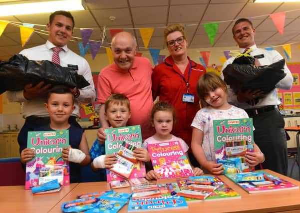 Children at Sunderland Royal Hospital  receive colouring books and pens.
Children from left Calvin Caine, six, Kian Clements, four, Lilah Downing, four and Amy Note, six. Back from left Elder Hopkins, Norman Imms, Carole Davison and Elder Palmer.