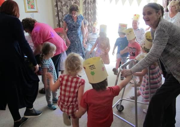 Divine Care Home residents and the children having a dance.