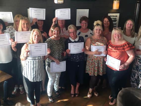 Hartlepool care workers with their long service certificates.