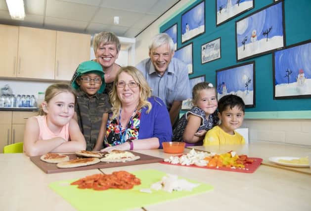 Northumbria University Prof Greta Defeyter with Children North East Chief Executive Jeremy Cripps and Gillian Gibson, Extended Services Manager at Bridgewater School with holiday club children.