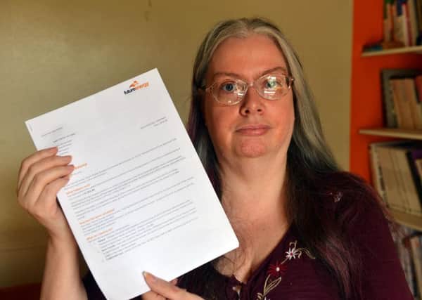 Nicola Lane with the energy bill which she disputed and has now had paid back to her.