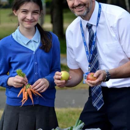 Ward Jackson Primary School pupil Ellie Wood sells vegetables to headteacher =David Akers. Picture by FRANK REID