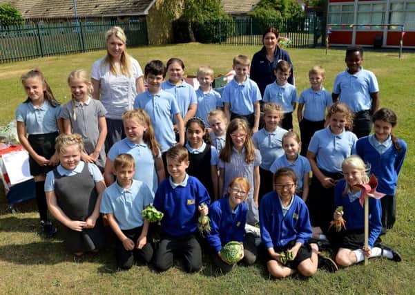 Ward Jackson Primary School class teacher Jenni Petch (left) and Angie Dawson from Tesco Extra Burn Road with Ward Jackson pupils with a selection of vegetables they planted and grew at the school. Picture by FRANK REID