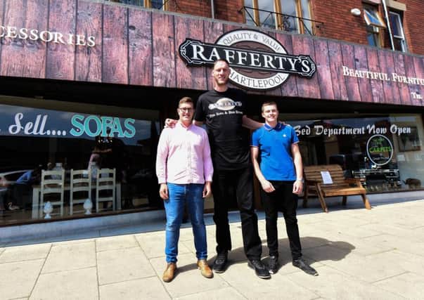 Britain's tallest man Paul Sturgess callred in at Rafferty's in York Road, hartlepool, yesterday (Wednesday) to pick up the new bed they had made for him.  Paul with Joe Rafferty (left) and Charlie Rafferty (right)