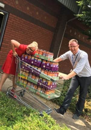 Shonette Bason-Wood and Kyle Boddy collecting items for food hampers