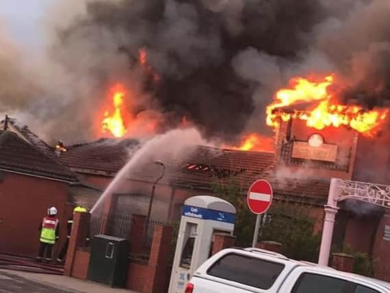 Firefighters fight the flames at the Longscar Centre. Photo by John David McDade.