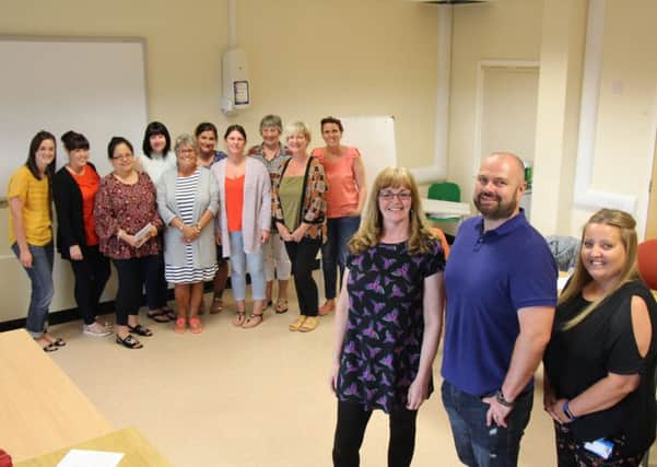 Community dementia nurse Janette McGuire, dementia specialist nurse Stephen Nicholson and occupational therapist Nicola Murphy with the latest group of dementia champions to complete the training.