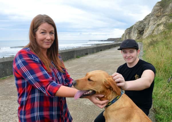 Helen McKenzie with Corey Waring and Bonnie the Labrador he saved along with his owner.