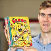 Robert Henshilwood, head of books at Keys auctioneers, holding the first ever Beano Annual, which is expected to sell for between Â£1,200 and Â£1,500. Pic: Andy Newman/PA Wire.