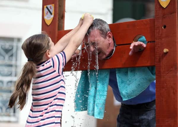 Parents In Need of Support summer fete takes place at the Support Dimensional House in Hartlepool. Martha Cawley (7) throws sponges at Hartlepool MP Mike Hill. Picture: CHRIS BOOTH