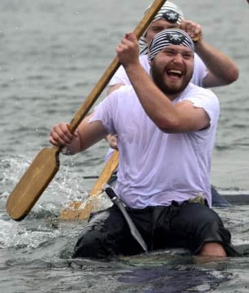 A happy pirate completes the raft race.